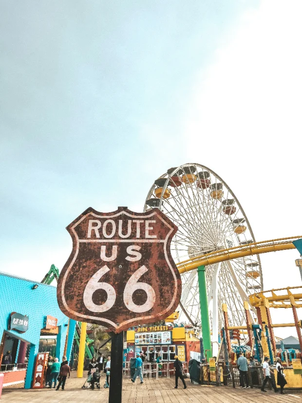 The Santa Monica Pier: a Route 66 sign in front of the Ferris wheel